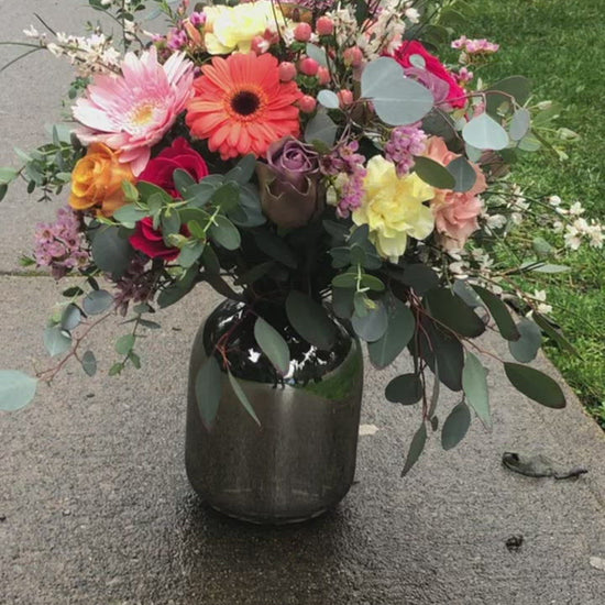 cheerful flowers in a silver vase arrangement. flower delivery for mothers day in richmond, bc