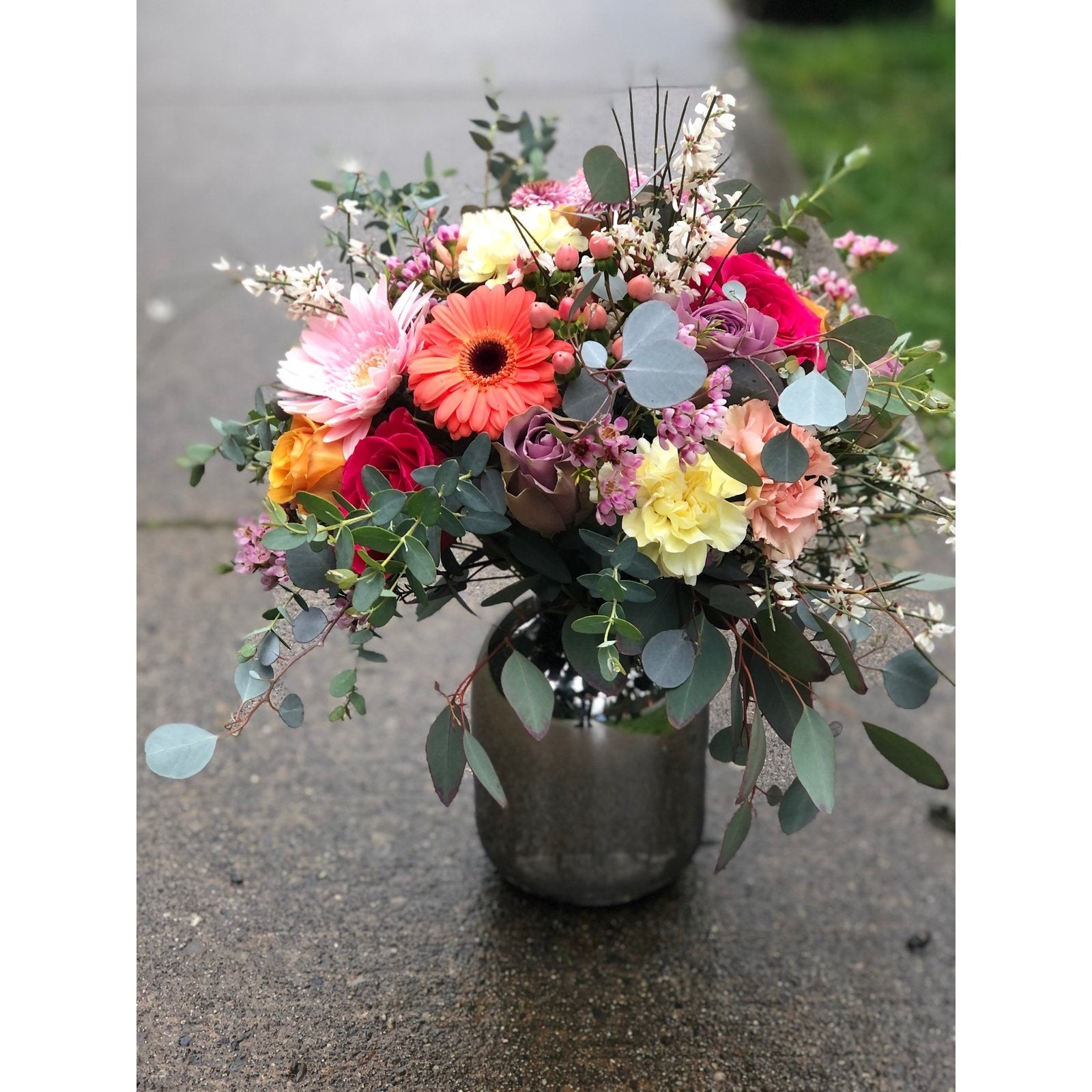 cheerful flowers in a silver vase arrangement. flower delivery for mothers day in richmond, bc