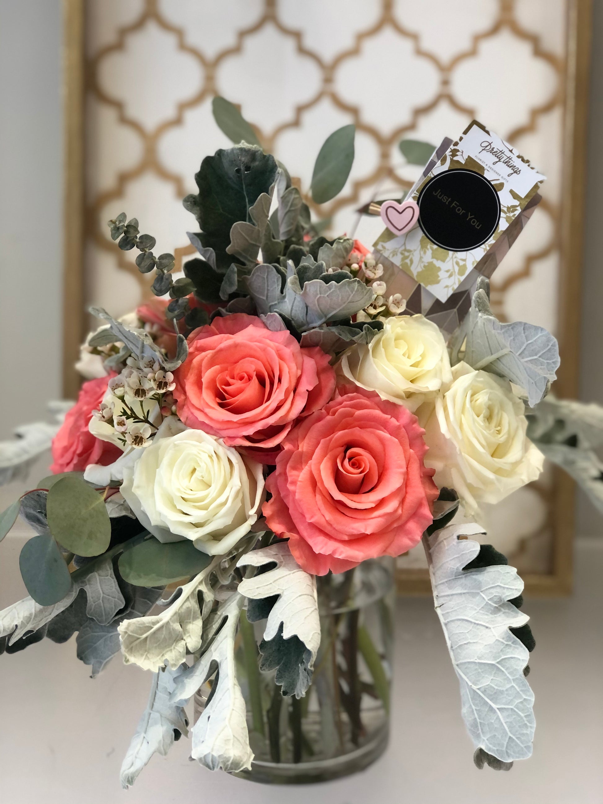 mothers day rose arrangement.coral pink and white roses with greenery